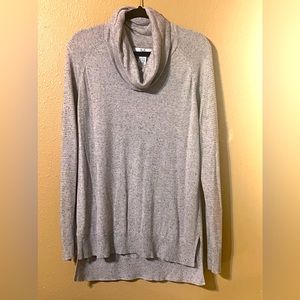 Cowl neck sweater with contrasting knit pattern on sleeves.